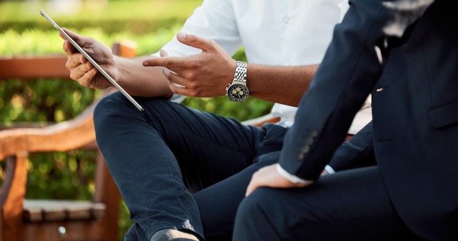 man explaining with tablet in hand
